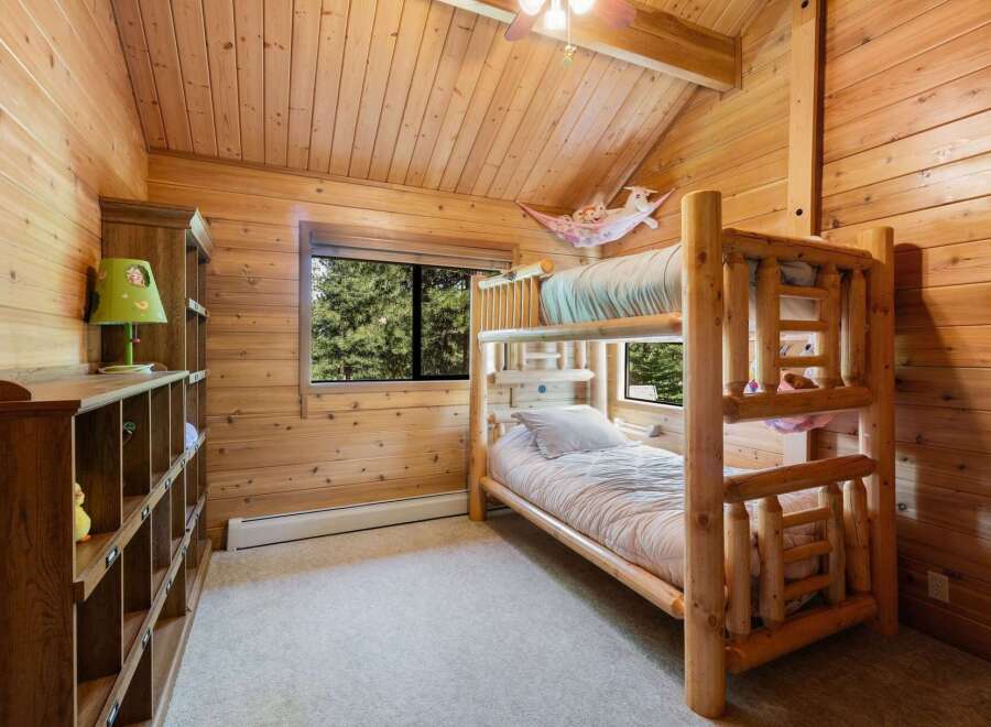 This charming bedroom features a rustic bunk bed, perfect for a cozy and inviting space.