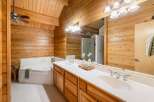 Step into a luxurious bathroom retreat featuring stunning wood paneling and a spacious layout.