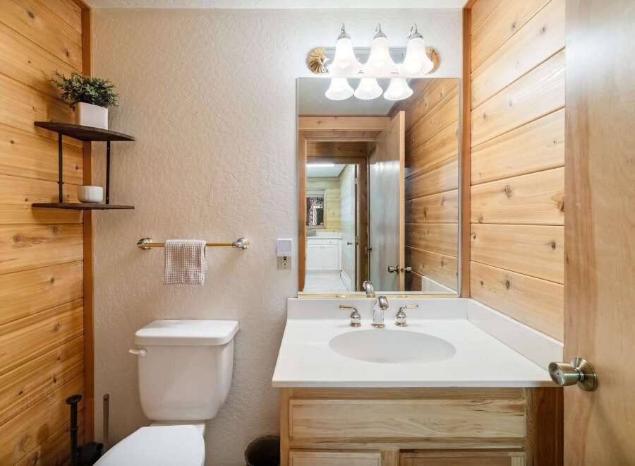 This charming bathroom features a rustic wooden design, creating a warm and inviting atmosphere.