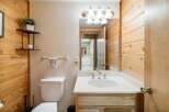 This charming bathroom features a rustic wooden design, creating a warm and inviting atmosphere.
