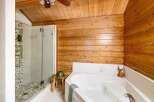 This stunning bathroom boasts a luxurious soaking tub and a separate glass-enclosed shower, perfect for unwinding after a long day.