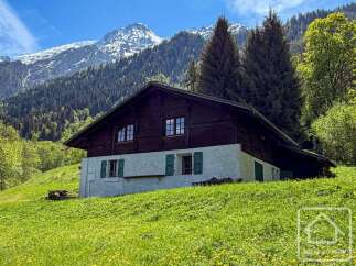 Nestled in a picturesque mountain setting, this charming chalet offers a tranquil escape.