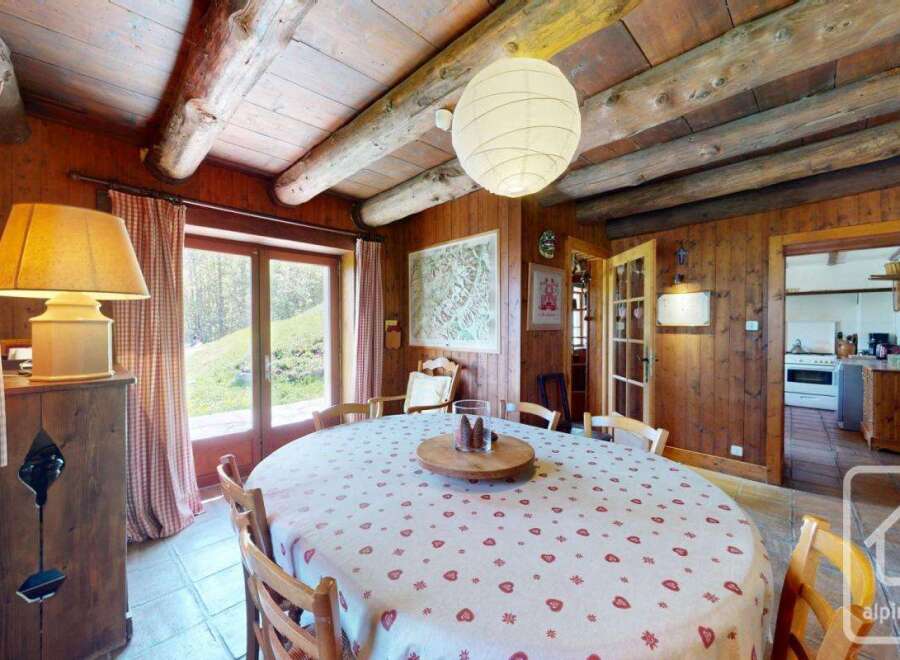 Step into this charming dining room, featuring a rustic wooden interior and a cozy ambiance.