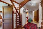 Step into a charming property with rustic wooden beams and a welcoming hallway.