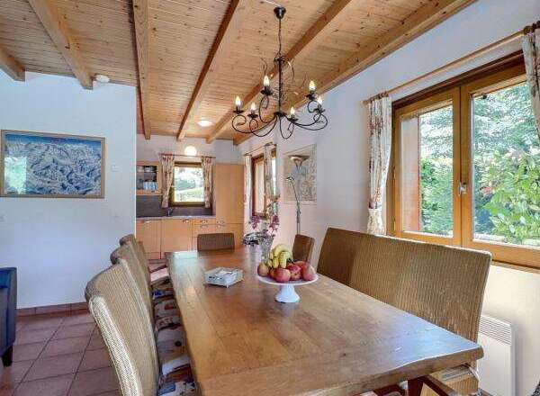 This charming dining area features a rustic wooden table, perfect for family gatherings.