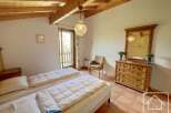 This charming bedroom features a cozy atmosphere with wooden beams and a warm color palette.