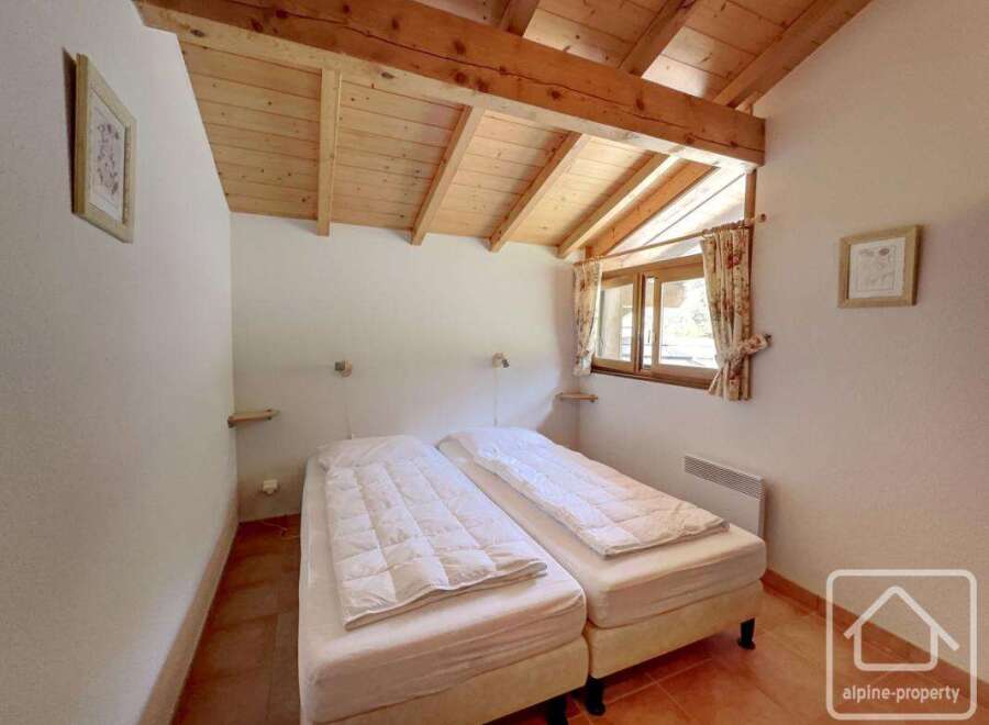 Discover the charm of this cozy bedroom featuring two comfortable beds, perfect for a relaxing stay.