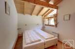 Discover the charm of this cozy bedroom featuring two comfortable beds, perfect for a relaxing stay.