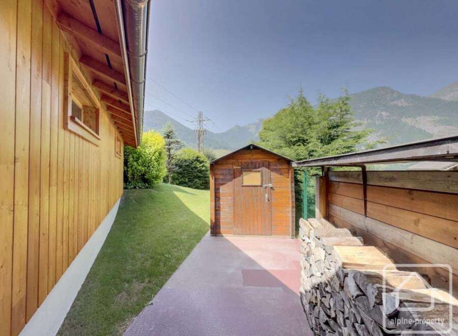 Discover the charm of this property, featuring a cozy wooden shed and a beautifully stacked woodpile.