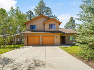This stunning two-story home boasts a beautiful exterior with a spacious driveway and lush landscaping.