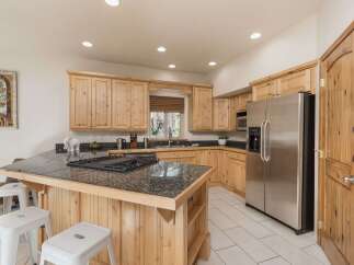 This stunning kitchen boasts custom cabinetry and a spacious island, perfect for culinary enthusiasts.