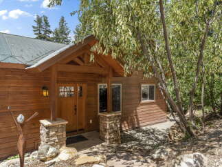 Nestled amidst lush greenery, this charming cabin offers a serene retreat.