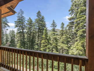 Enjoy breathtaking views of the surrounding forest from this stunning property.