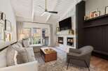 Step into luxury with this stunning property, featuring a cozy living room with a fireplace and a modern design.