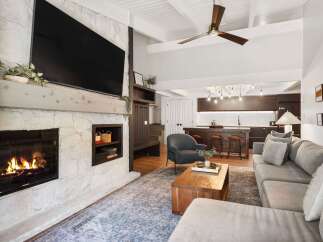 This stunning living room boasts a cozy fireplace, perfect for chilly evenings.