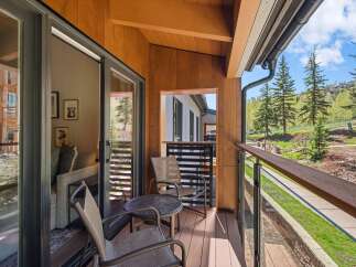 Enjoy breathtaking views from this stunning balcony! This outdoor space features a cozy seating area, perfect for relaxing and taking in the surrounding natural beauty.