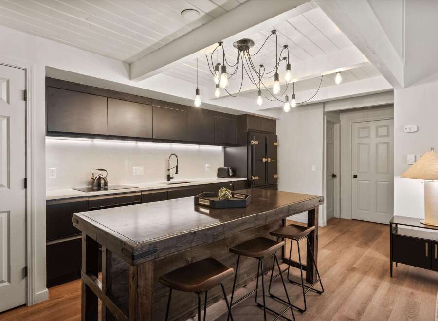 This stunning kitchen boasts a modern design with sleek, dark cabinetry and a striking island.