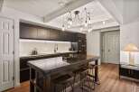 This stunning kitchen boasts a modern design with sleek, dark cabinetry and a striking island.