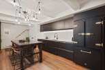 Step into this stunning kitchen, featuring sleek black cabinetry and a striking island.
