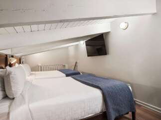 Discover the charm of this cozy bedroom featuring two comfortable beds, perfect for guests or a relaxing retreat.