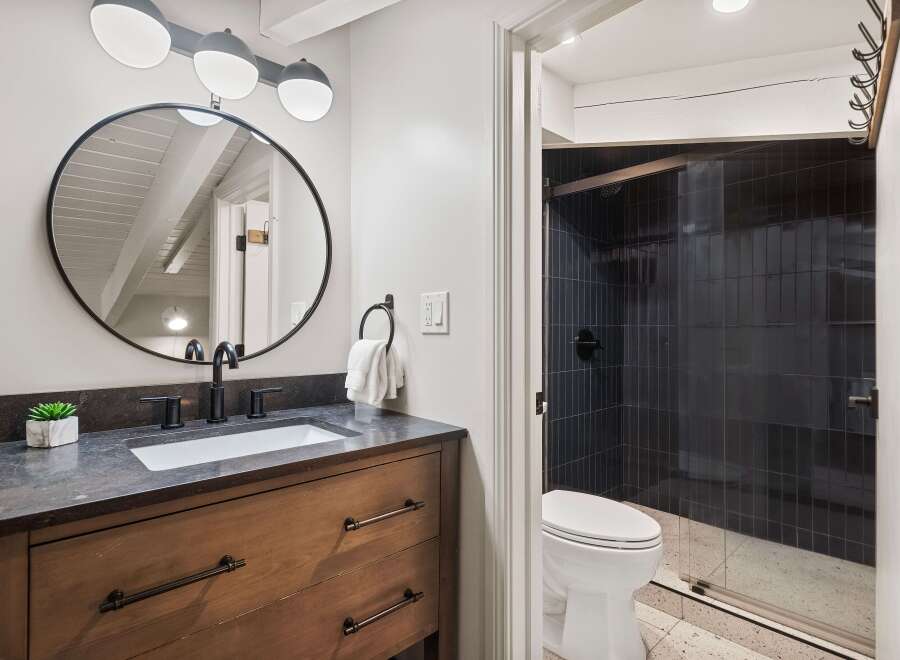This stunning bathroom boasts a modern design with sleek black fixtures and a stylish vanity.