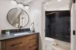 This stunning bathroom boasts a modern design with sleek black fixtures and a stylish vanity.