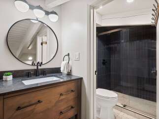 This stunning bathroom boasts a modern design with sleek black fixtures and a stylish vanity.