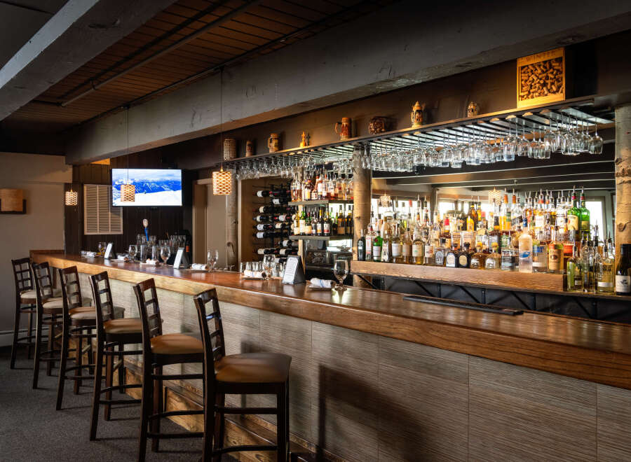 This inviting bar area features a warm, rustic ambiance, perfect for a cozy gathering.