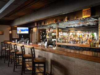 This inviting bar area features a warm, rustic ambiance, perfect for a cozy gathering.