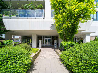 Discover modern living at this stunning property, featuring a beautifully landscaped entrance and a welcoming facade.