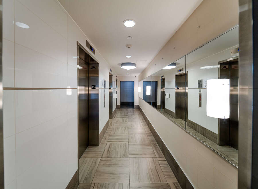 Step into luxury with this stunning hallway featuring modern elevators and elegant design.