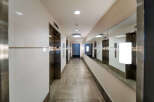 Step into luxury with this stunning hallway featuring modern elevators and elegant design.