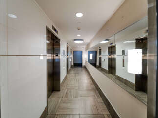 Step into luxury with this stunning hallway featuring modern elevators and elegant design.