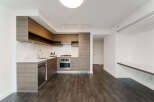 This modern kitchen boasts sleek cabinetry, stainless steel appliances, and a pristine white countertop.