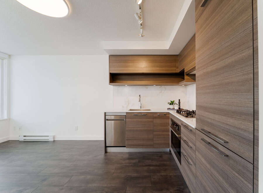 Discover modern living in this stunning kitchen! Featuring sleek cabinetry, stainless steel appliances, and a pristine countertop, this space is perfect for culinary enthusiasts.
