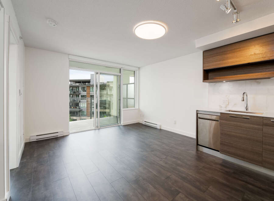Discover modern living in this stunning apartment! Featuring sleek, dark wood flooring and a contemporary kitchen with stainless steel appliances, this space is designed for comfort and style.
