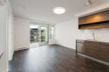 Discover modern living in this stunning apartment! Featuring sleek, dark wood flooring and a contemporary kitchen with stainless steel appliances, this space is designed for comfort and style.