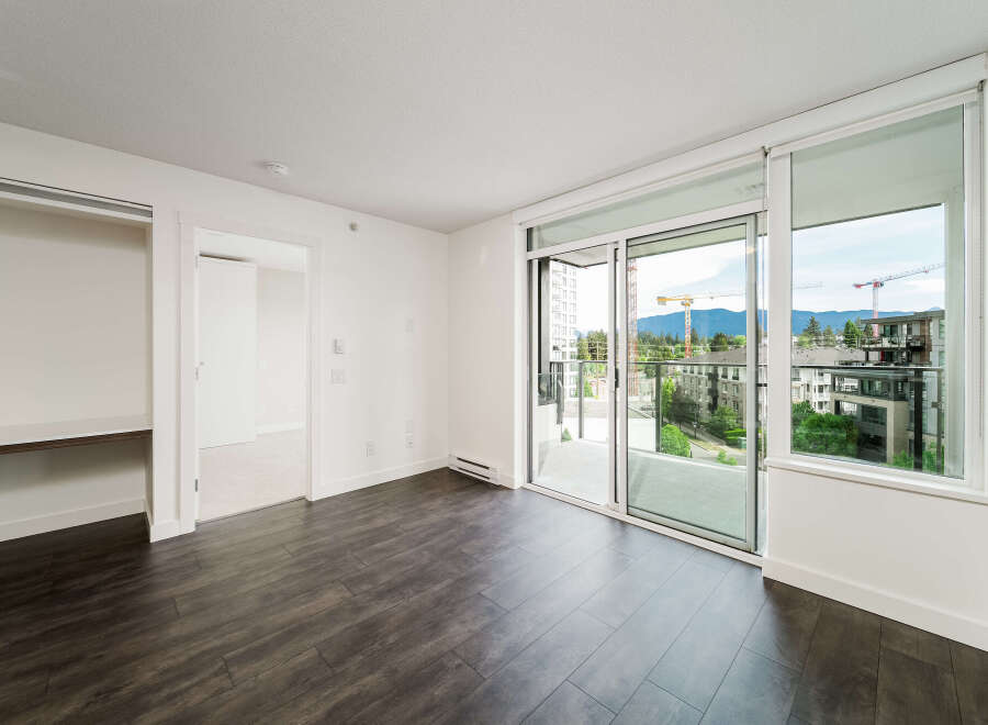 This stunning property boasts a modern interior with sleek dark wood flooring and bright white walls, creating a sophisticated ambiance.