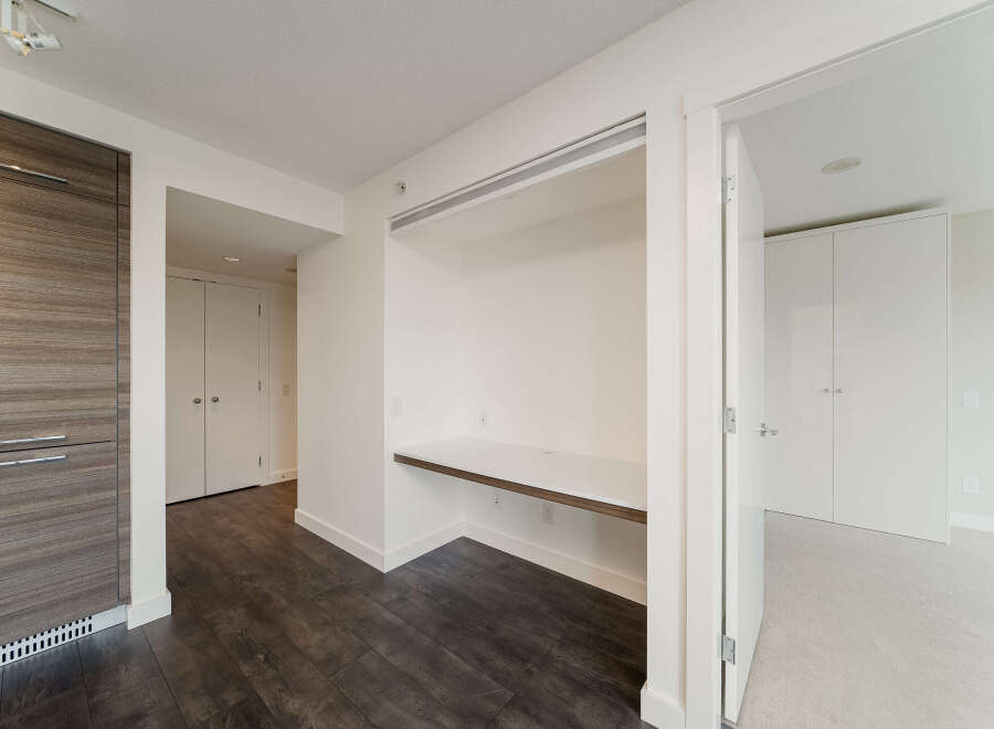 Discover modern living in this stylish property, featuring a built-in desk area perfect for a home office or study space.