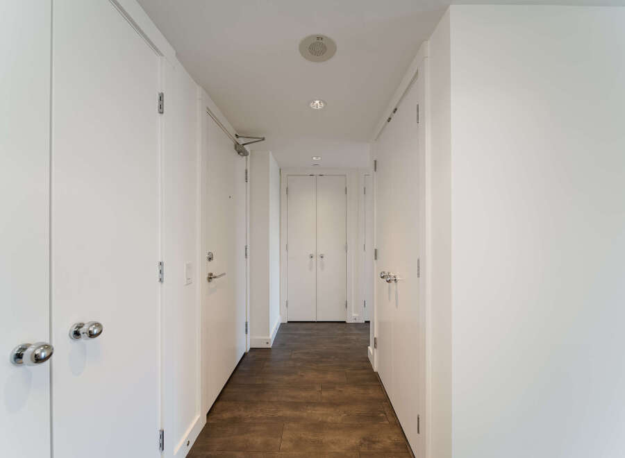 This stunning hallway showcases a modern design with clean lines and a neutral color palette.