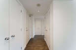 This stunning hallway showcases a modern design with clean lines and a neutral color palette.