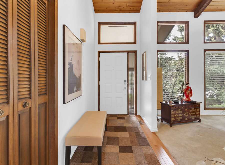 Step into this inviting entryway, showcasing a blend of classic and contemporary design.