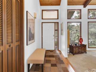 Step into this inviting entryway, showcasing a blend of classic and contemporary design.