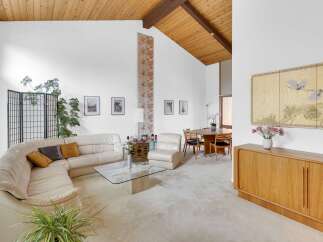 Step into this stunning mid-century modern home, showcasing a bright and airy living space.