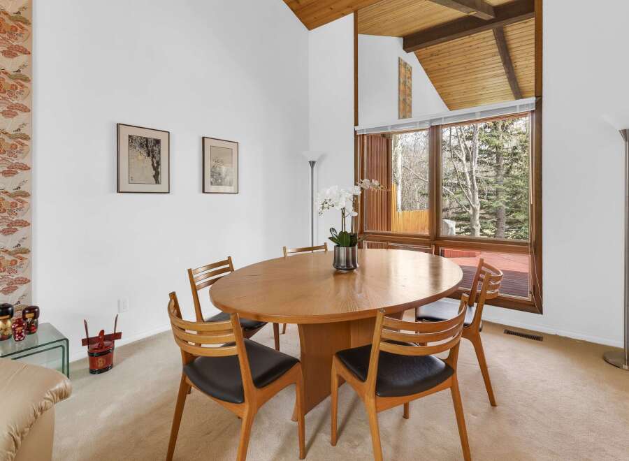 This stunning dining room features a beautiful oval wooden table and stylish chairs, perfect for hosting gatherings.