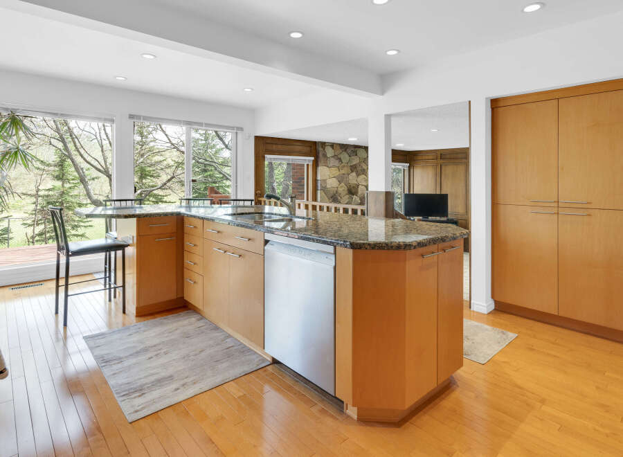This stunning kitchen boasts a modern design with sleek cabinetry and granite countertops.