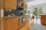 This stunning kitchen boasts modern cabinetry and sleek stainless steel appliances.