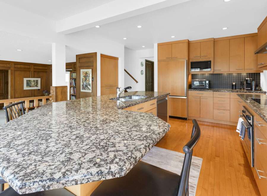 This stunning kitchen boasts a spacious granite countertop island, perfect for meal prep and entertaining.