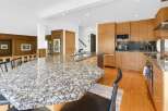 This stunning kitchen boasts a spacious granite countertop island, perfect for meal prep and entertaining.