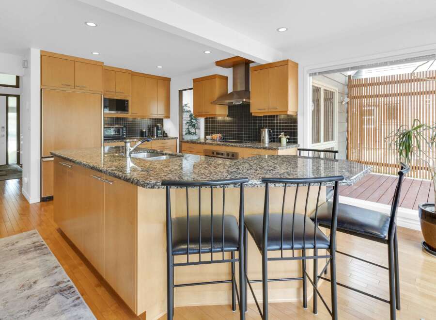 This stunning kitchen boasts a modern design with sleek cabinetry and a spacious island, perfect for both cooking and entertaining.